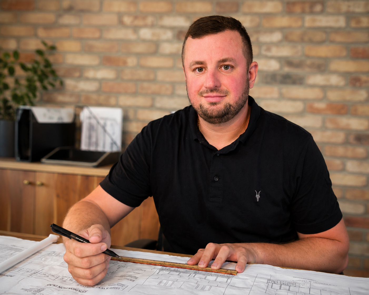 Founder of All Masonry Services reviewing architectural plans