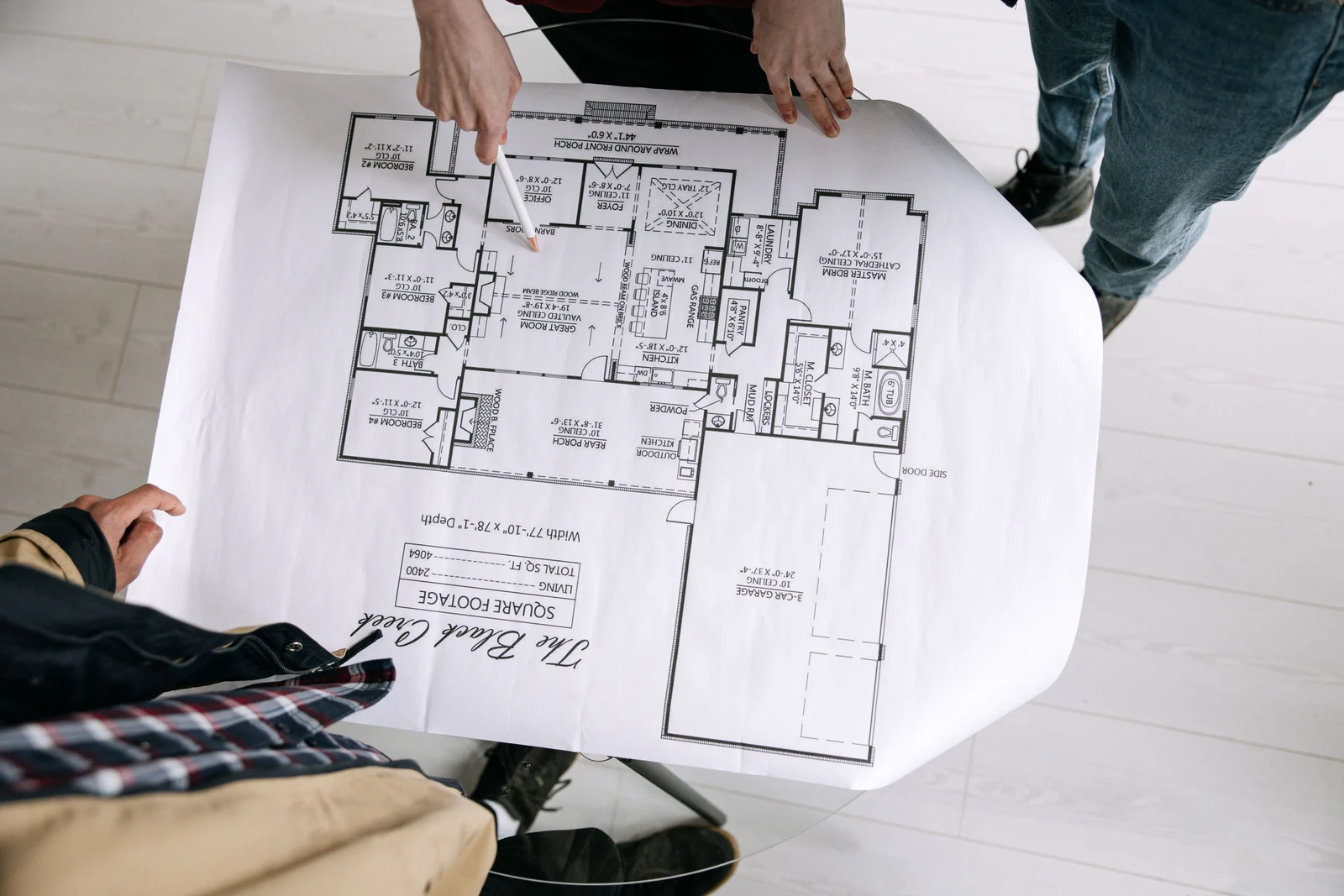 Architect reviewing blueprints for precise masonry detailing on a custom home