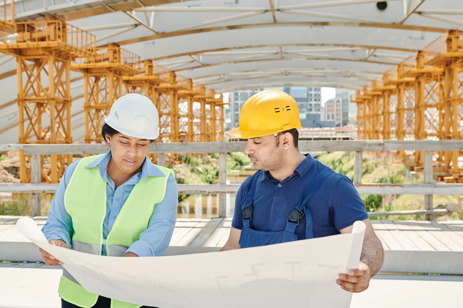 Our Mission — builder and homeowner reviewing veneer plans on a new construction site