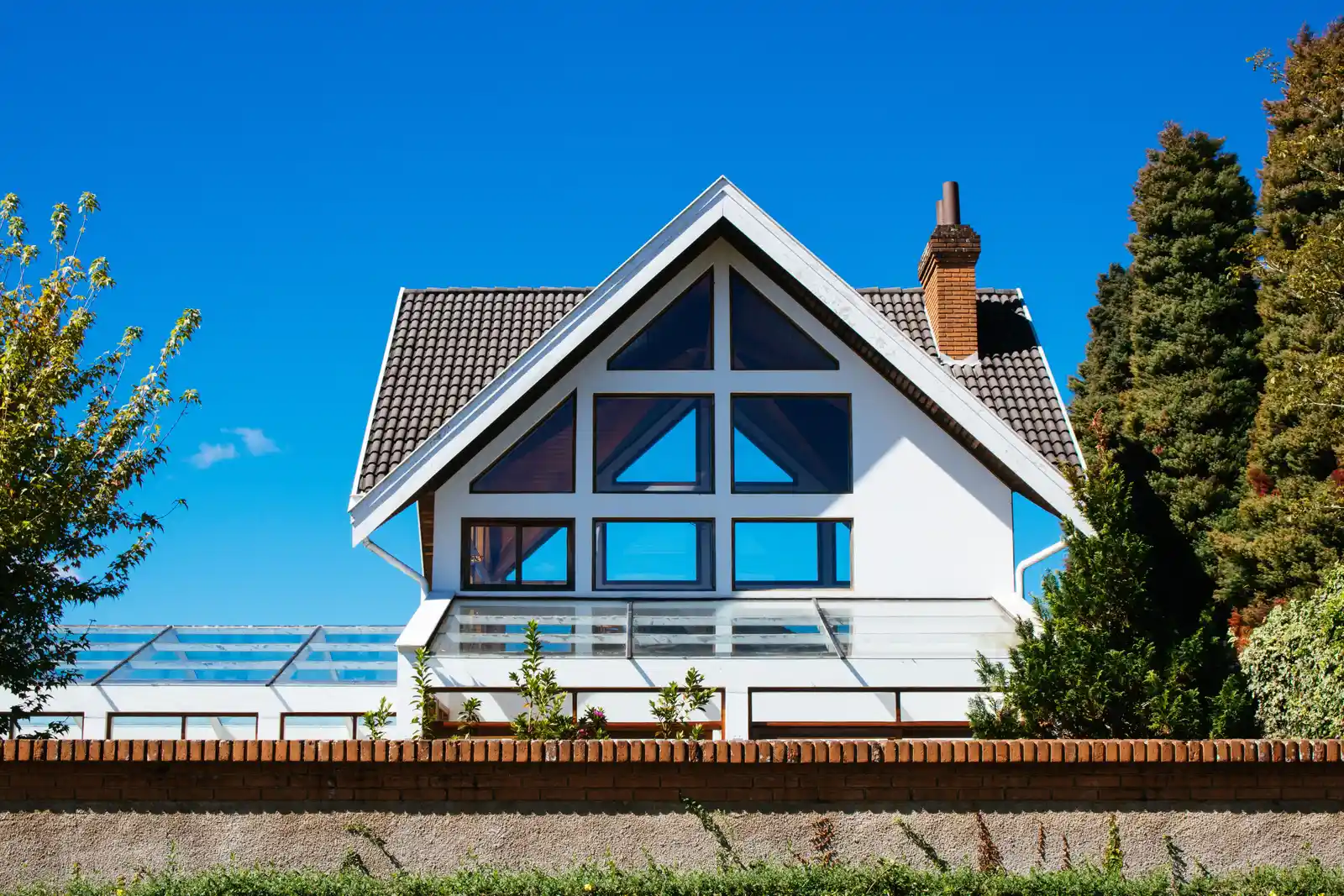 Our Vision — modern custom home with brick chimney built to last for decades