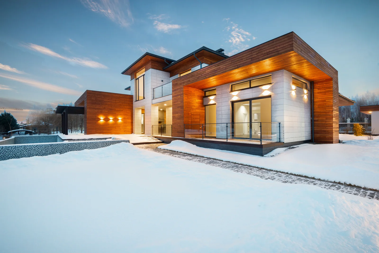 Modern custom home exterior with stone and wood masonry facade