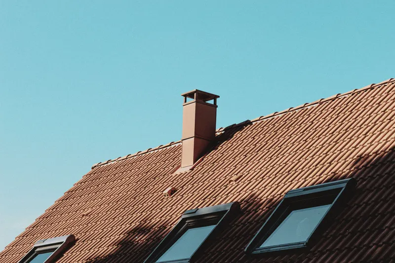 New brick chimney with metal rain cap and spark arrestor