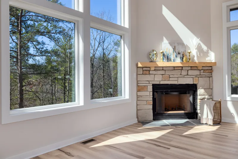 Custom stone fireplace hearth and wood mantel in a new home