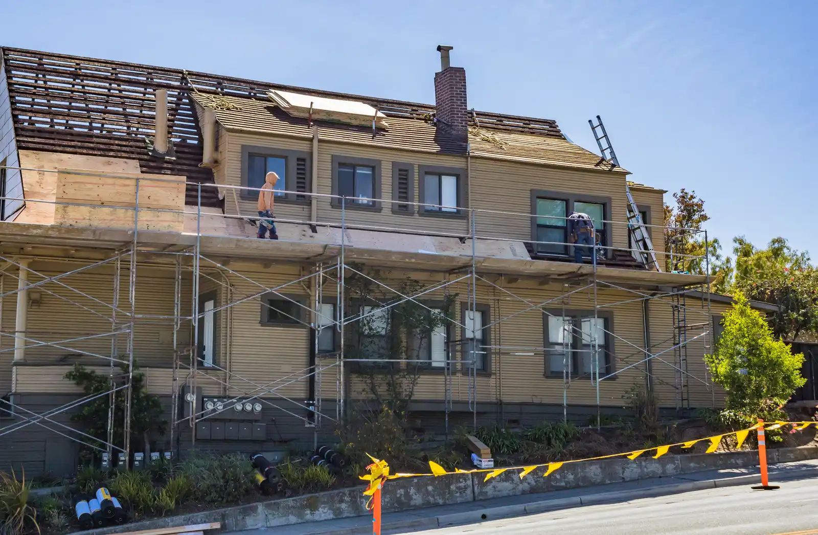 Before — active chimney rebuild with scaffolding around the roofline