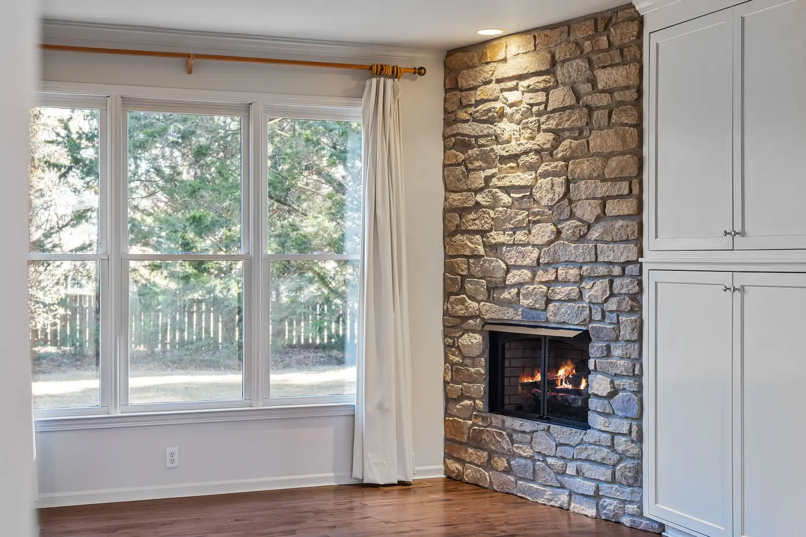 Custom stone fireplace surround built by AMS for a chimney and fireplace project