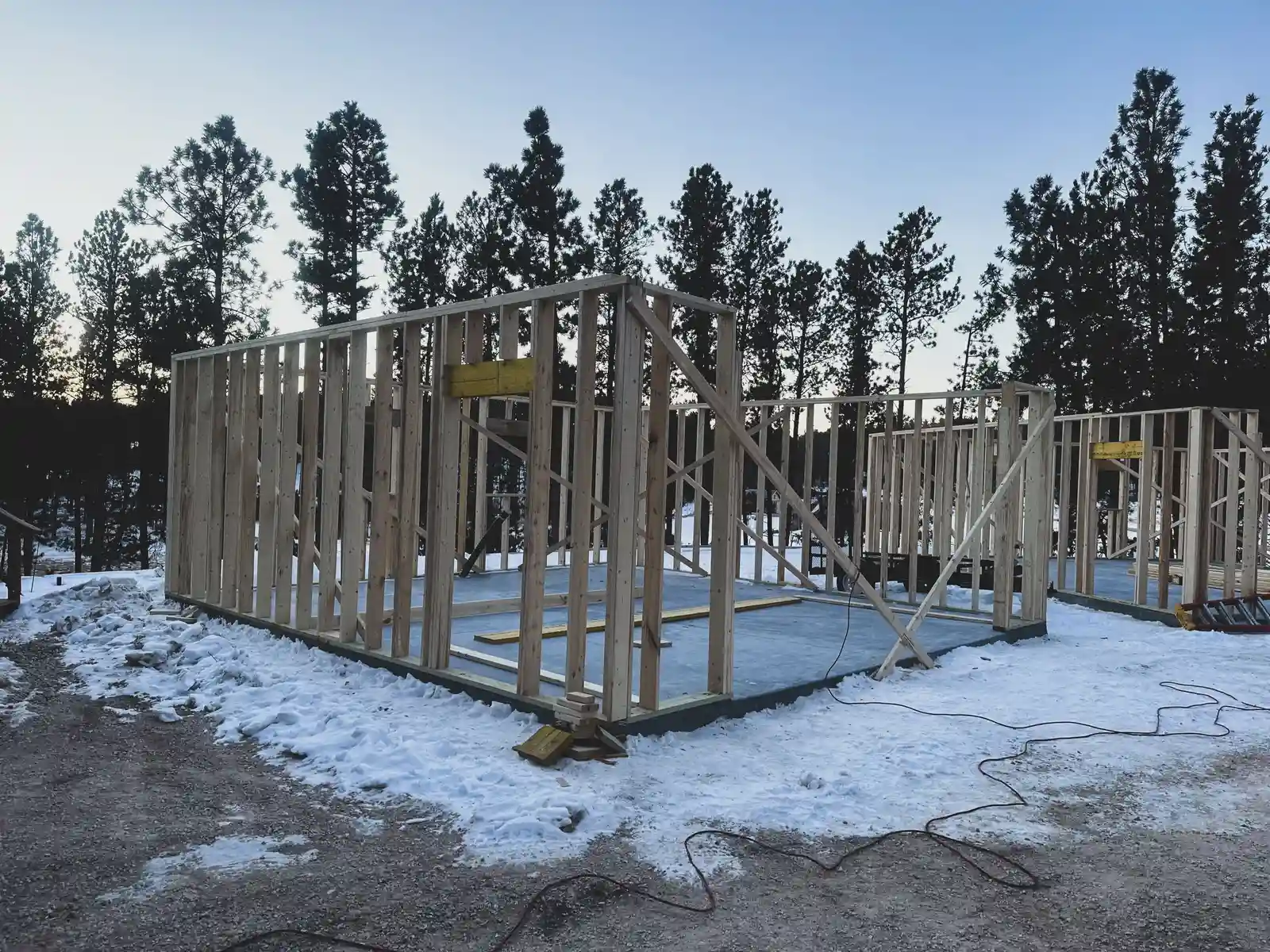 Before — wood-framed new home construction site ready for masonry