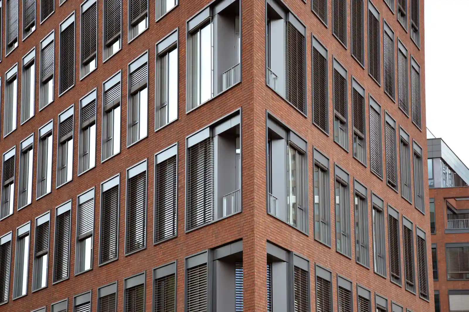 Large-scale commercial brick and stone masonry facade on a modern building