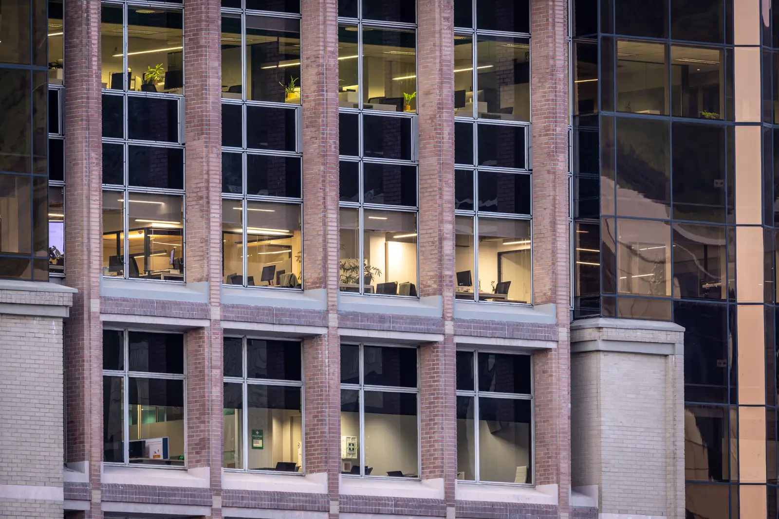 After: completed commercial brick and stone facade, inspection-approved