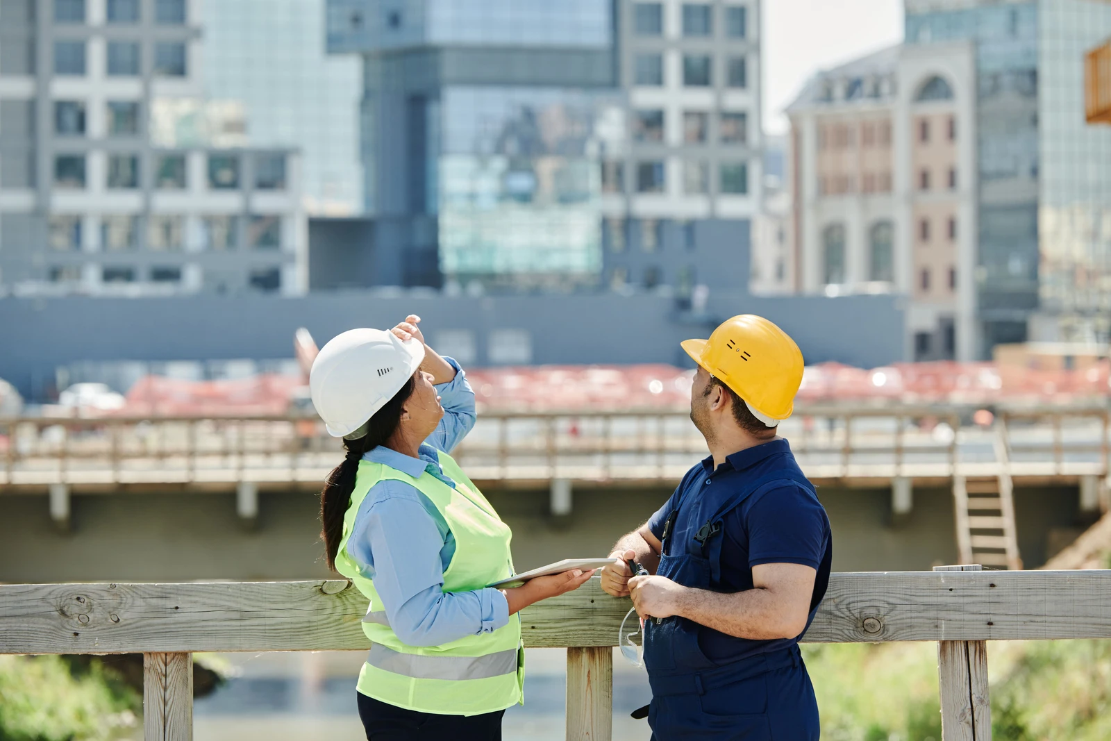 Our Mission — developer and site superintendent reviewing commercial building plans on site