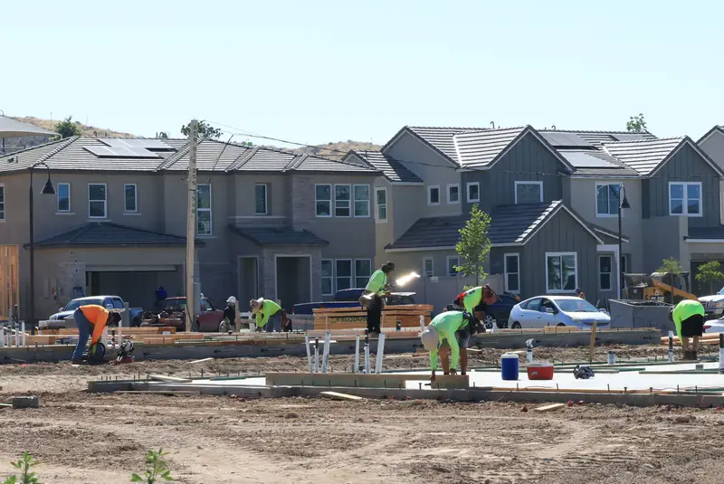 Construction crew building new homes together in a residential development