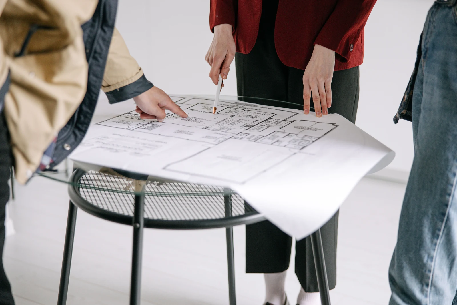 Our Mission — architect and clients reviewing floor plans for a stone facade build