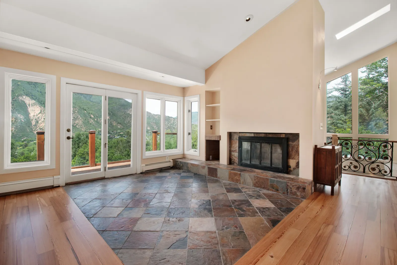 Custom stone hearth fireplace in a new construction living room