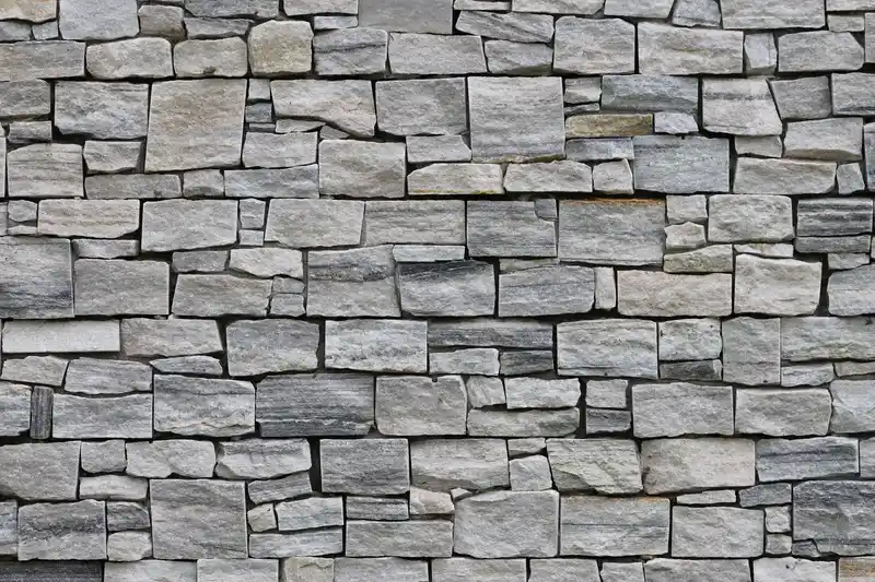 Coursed limestone ashlar facade engineered for structural load