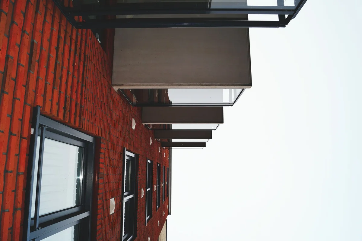 After: Front elevation — full-bed clay brick laid in running bond with consistent tooled joints