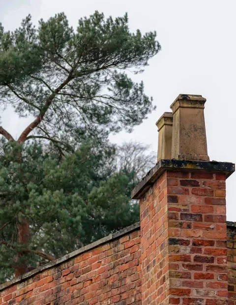 After: Side elevation — brick coursing over engineered tie and flashing system