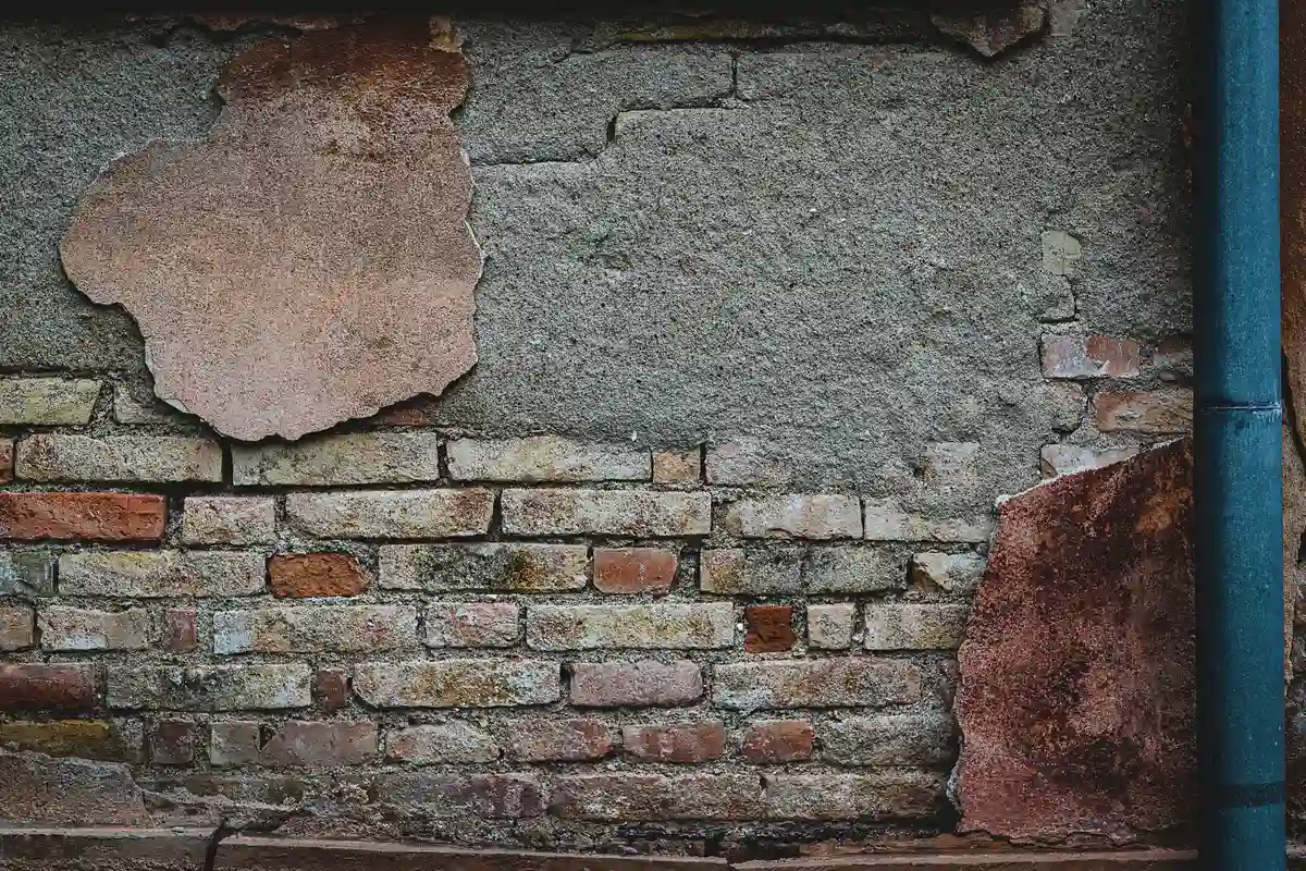 Before: Front elevation — stone veneer installed over continuous drainage plane with anchored ties