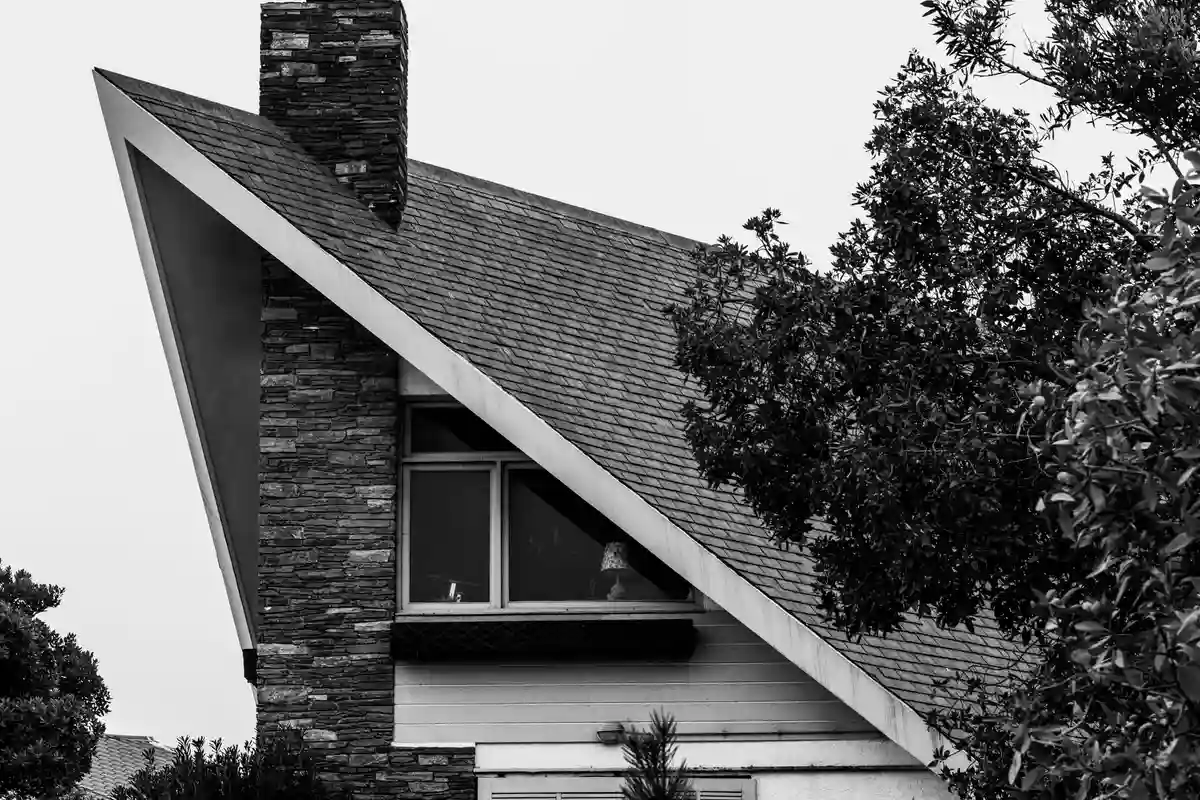 After: Chimney stack — new masonry chimney with poured crown, stainless cap, and woven flashing