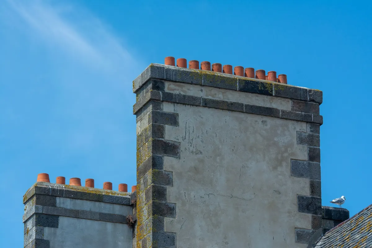 After: Base detail — new brick courses set plumb and level with correct mortar joint spacing