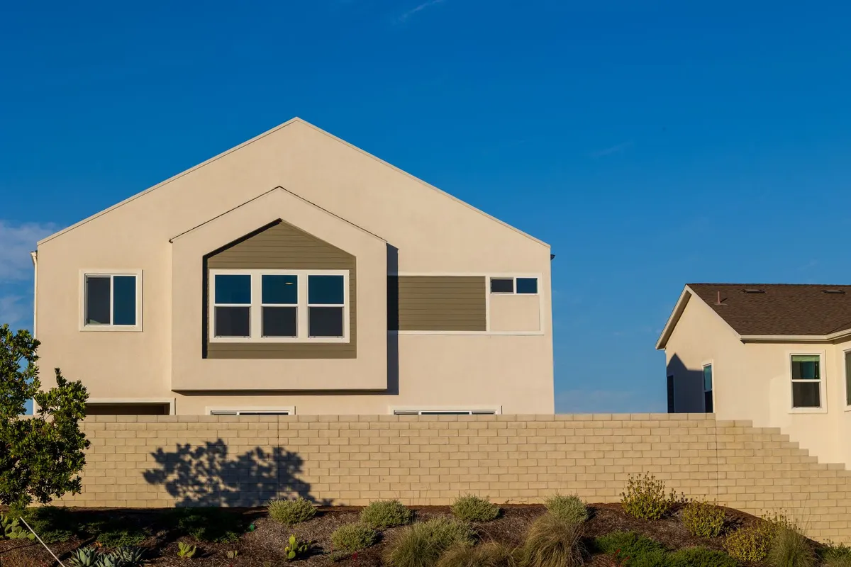 After: Front elevation — stone veneer installed over continuous drainage plane with anchored ties
