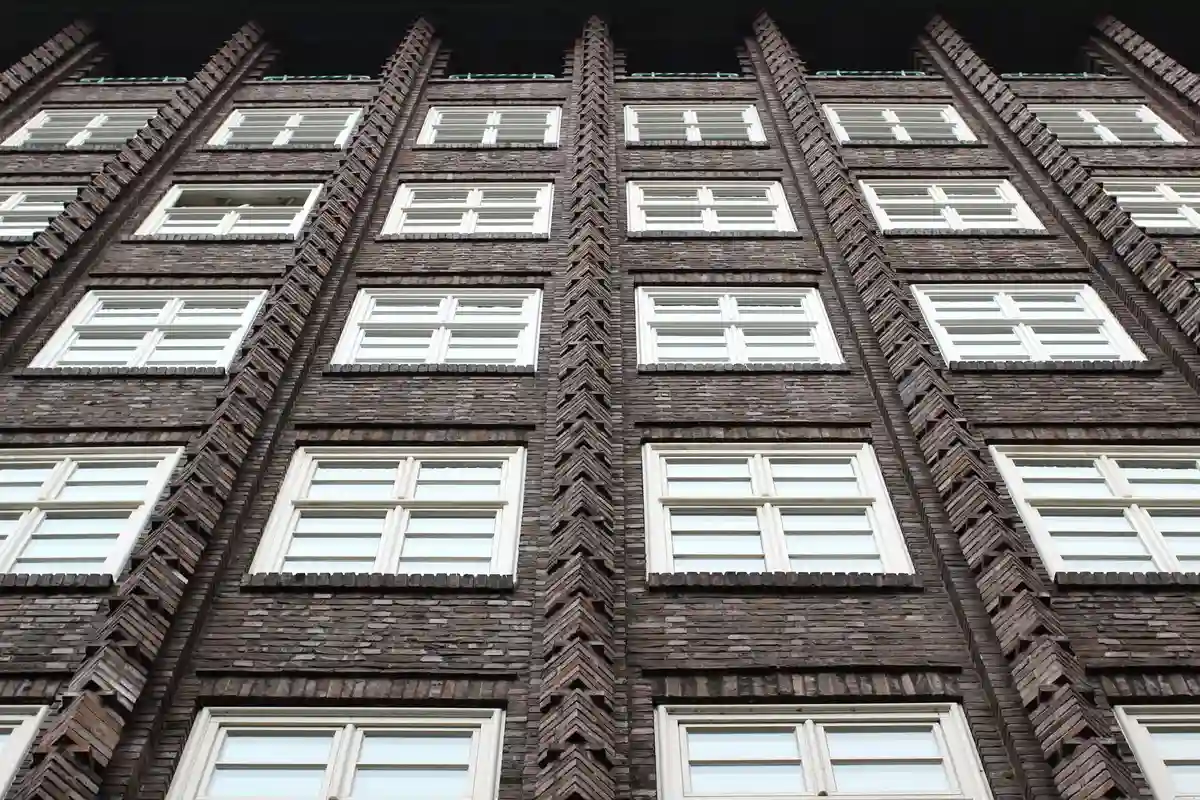 Before: Side elevation — veneer coursing with sill and cap detailing at window openings