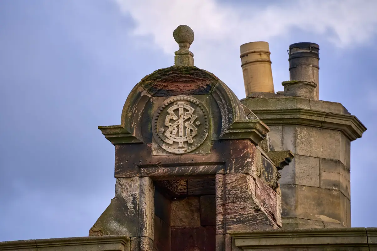 After: Roofline detail — chimney proportioned to the elevation with code-compliant clearances