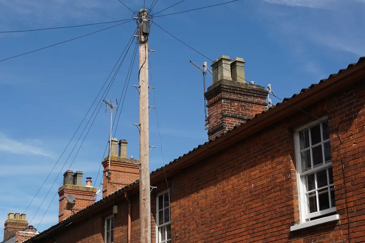 After: Full stack — original leaning chimney demolished to roofline and rebuilt in matching brick