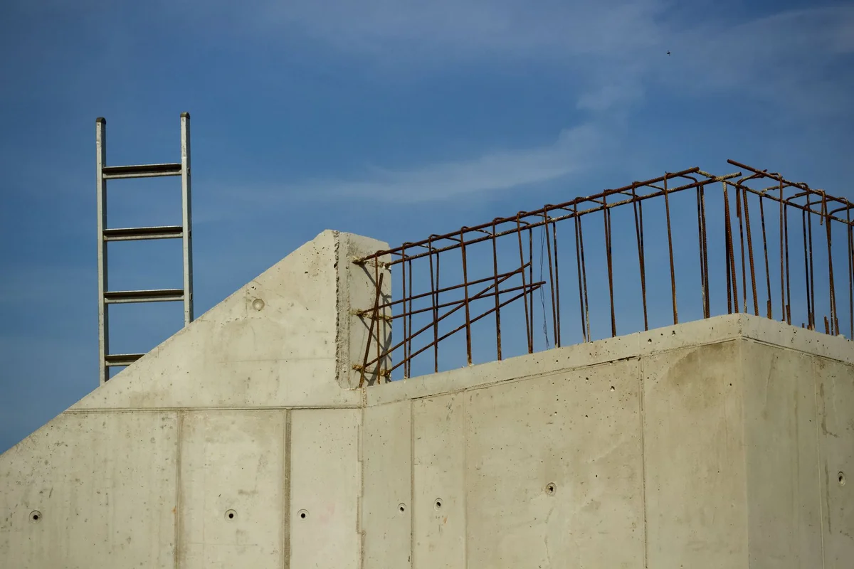 Before: Retaining wall — CMU block installed with vertical rebar and grout consolidation throughout