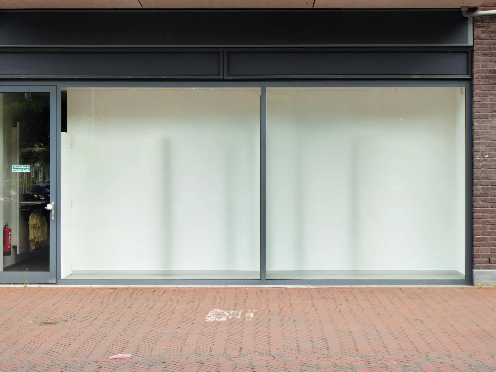 After: Main elevation — commercial brick installed with consistent coursing across the full facade