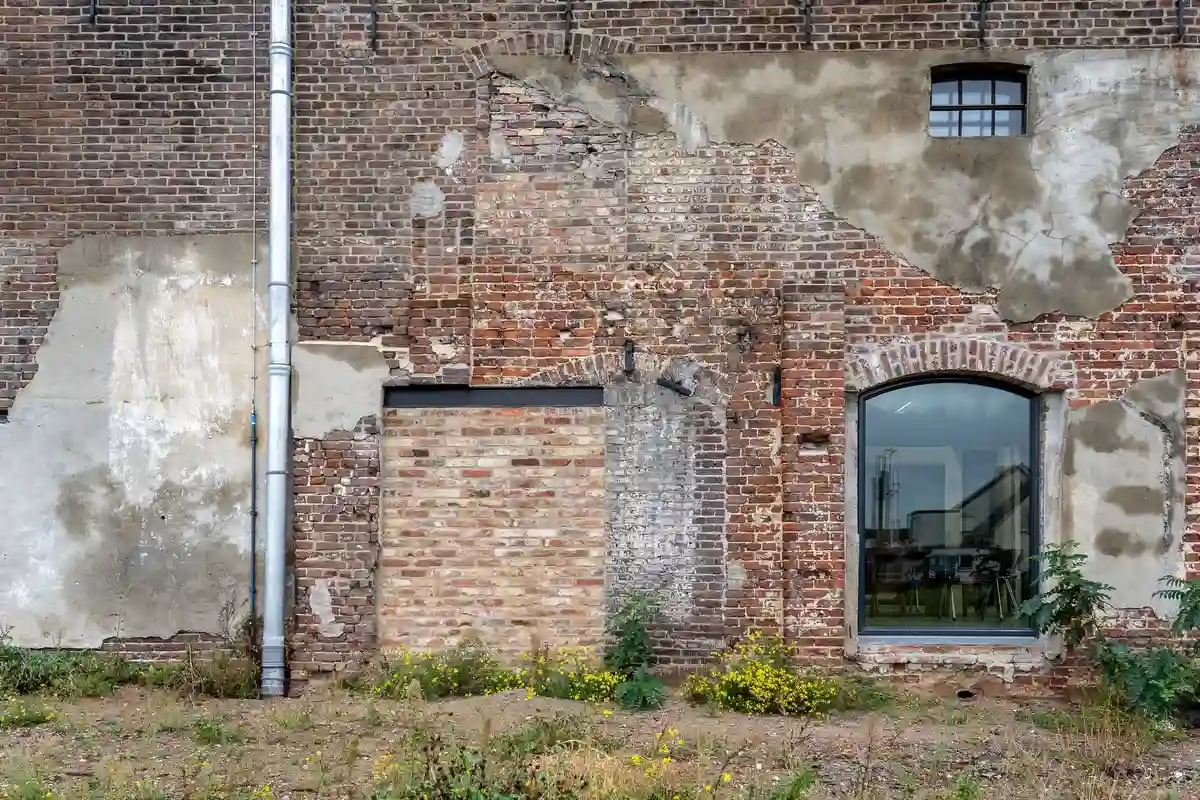 Before: Main elevation — commercial brick installed with consistent coursing across the full facade