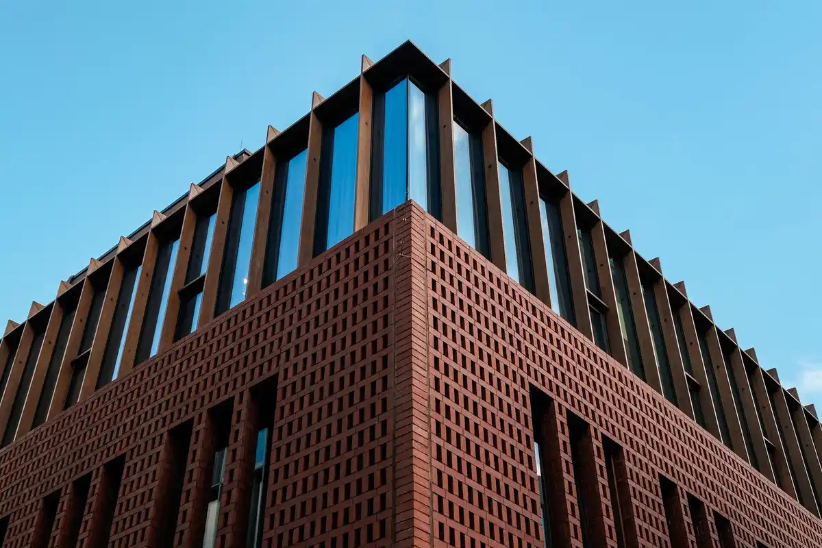 After: Main elevation — commercial brick installed with consistent coursing across the full facade