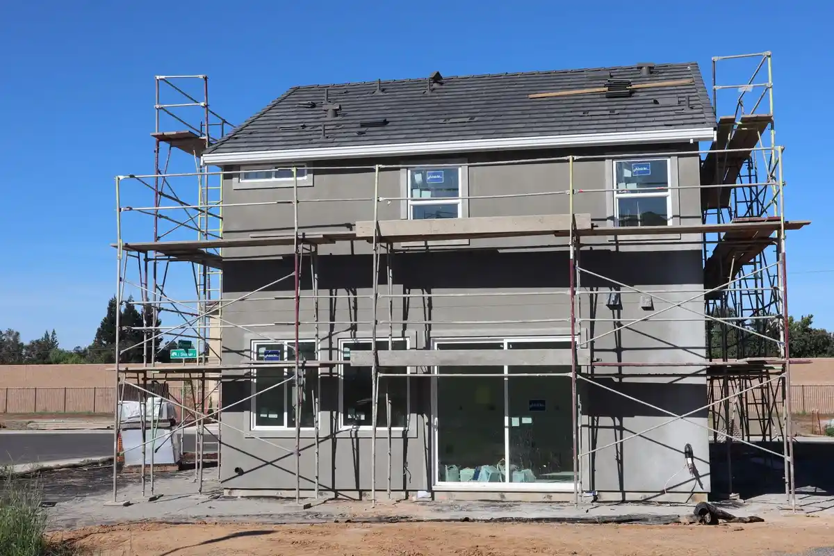 Before: Primary facade — full exterior brick and limestone installation from foundation to roofline