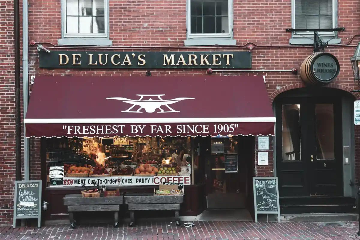 After: Storefront level — stone and brick detailing executed to architectural specification