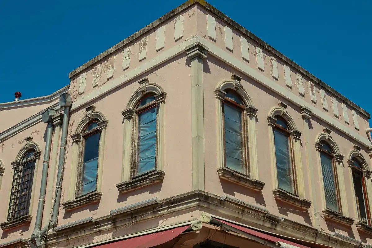 Before: Storefront level — stone and brick detailing executed to architectural specification
