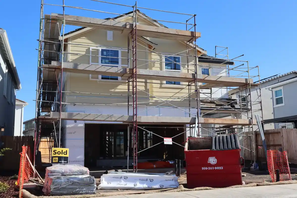 Before: Primary facade — full exterior brick and limestone installation from foundation to roofline