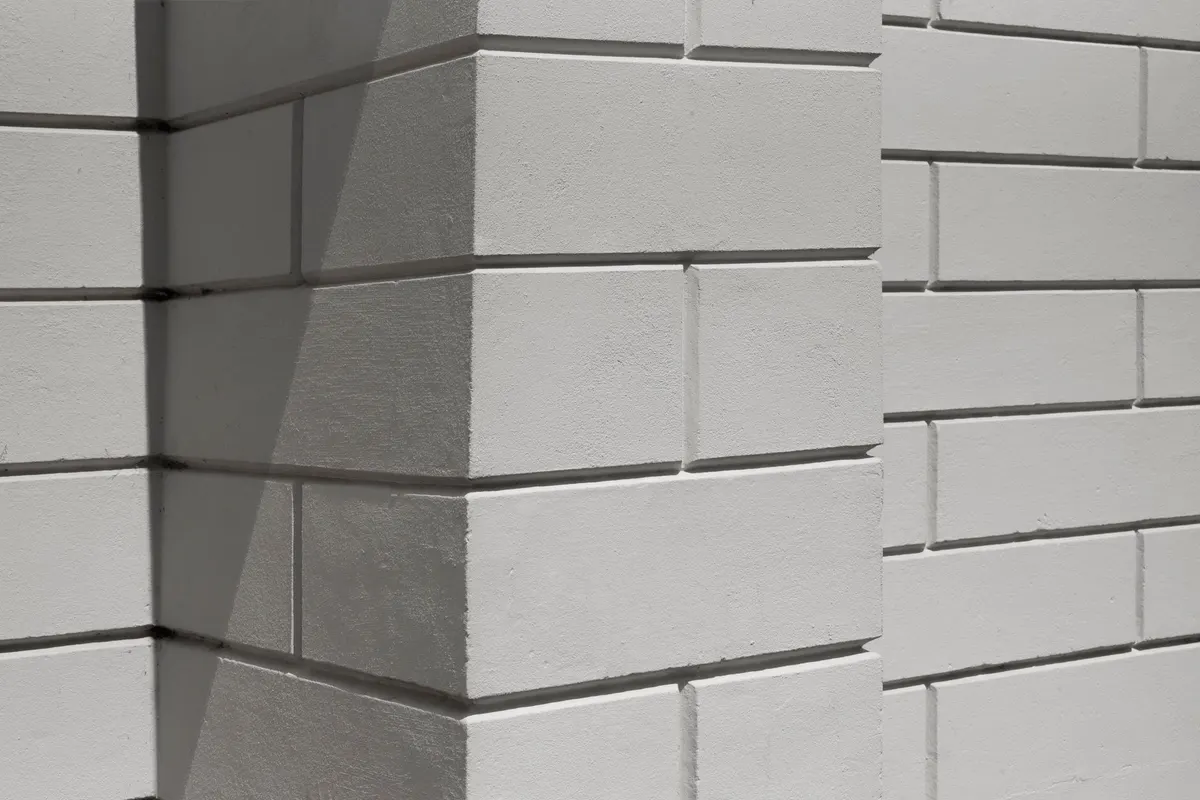 After: Main wall section — spalling brick removed and replaced with matched clay brick units
