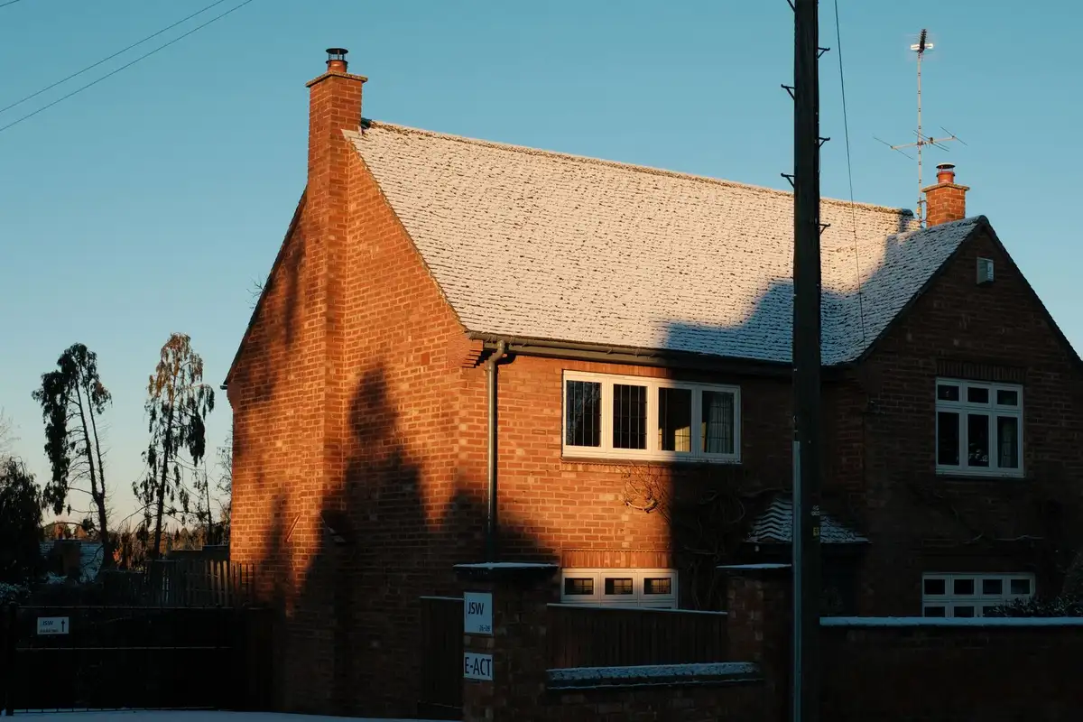 After: Full stack — original leaning chimney demolished to roofline and rebuilt in matching brick