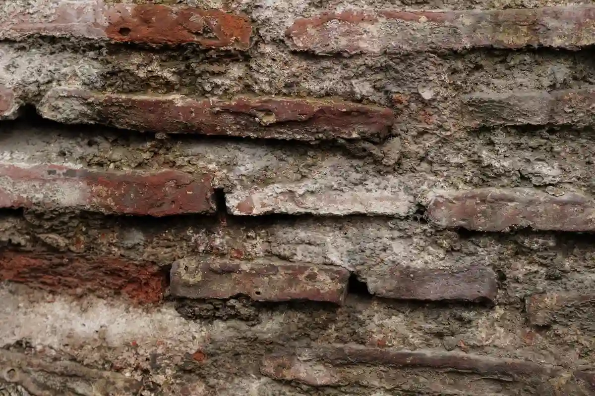 Before: Main wall section — spalling brick removed and replaced with matched clay brick units