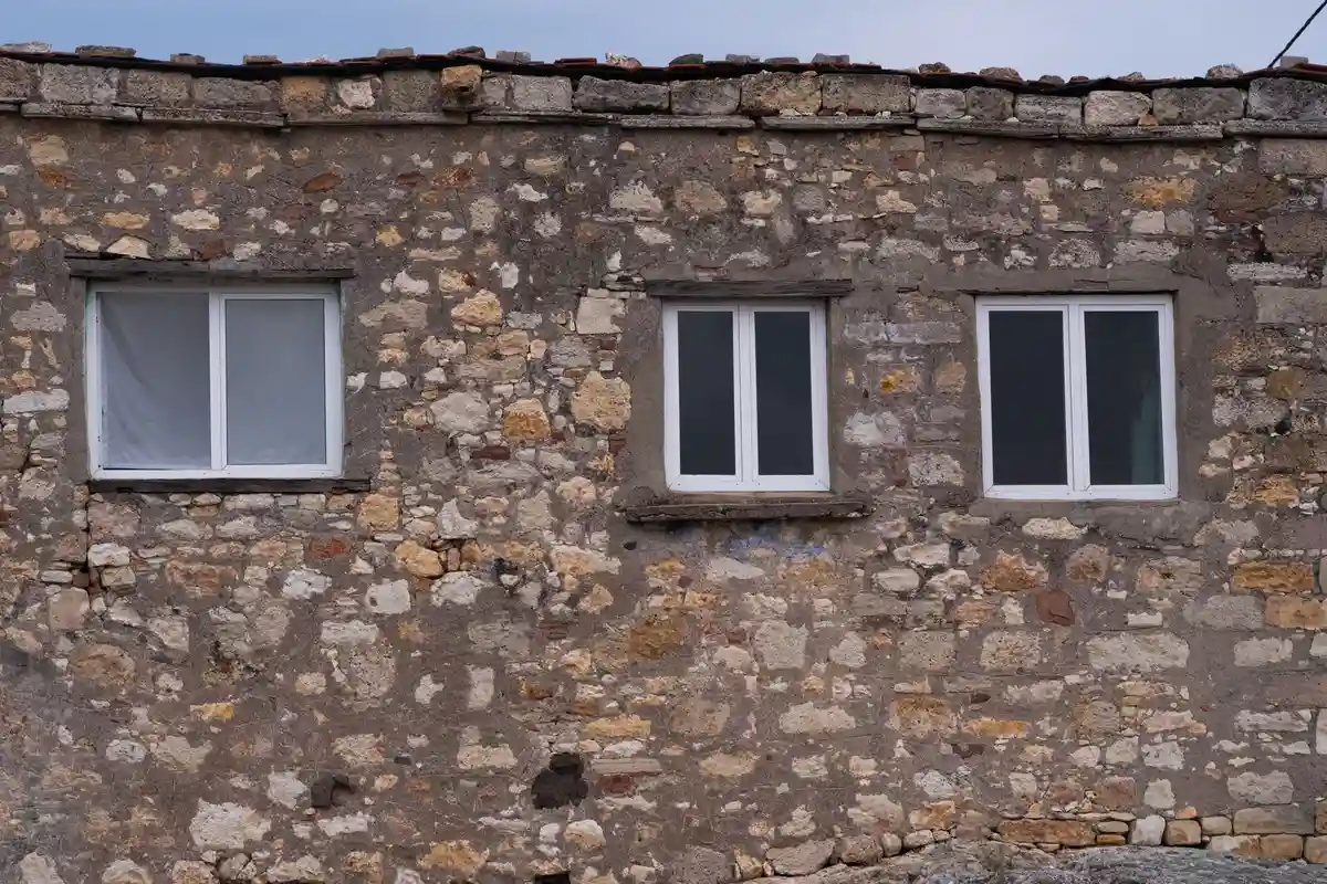 Before: Primary facade — full exterior brick and limestone installation from foundation to roofline