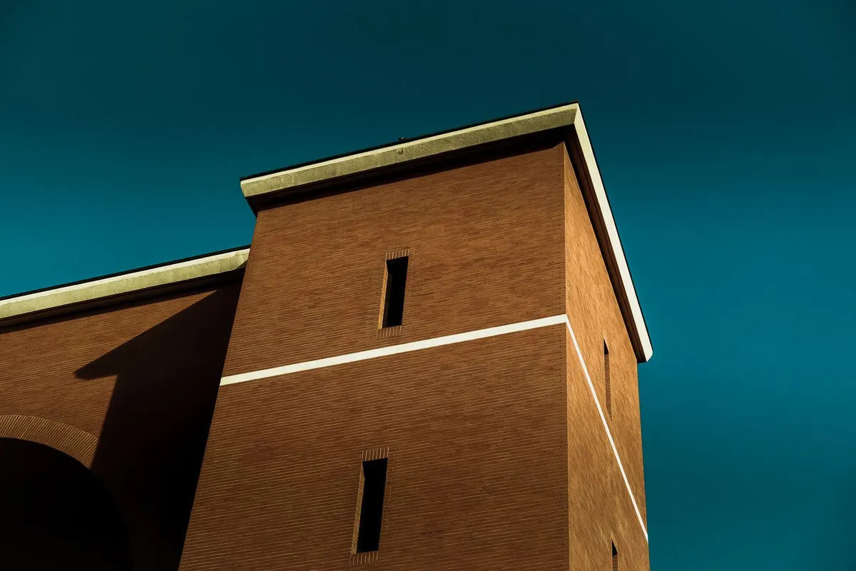 After: Main elevation — commercial brick installed with consistent coursing across the full facade