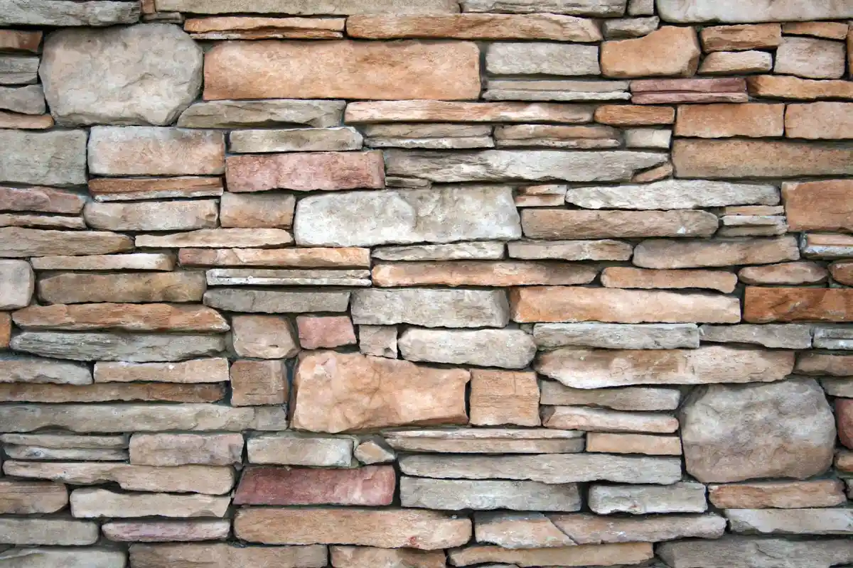 After: Front elevation — stone veneer installed over continuous drainage plane with anchored ties