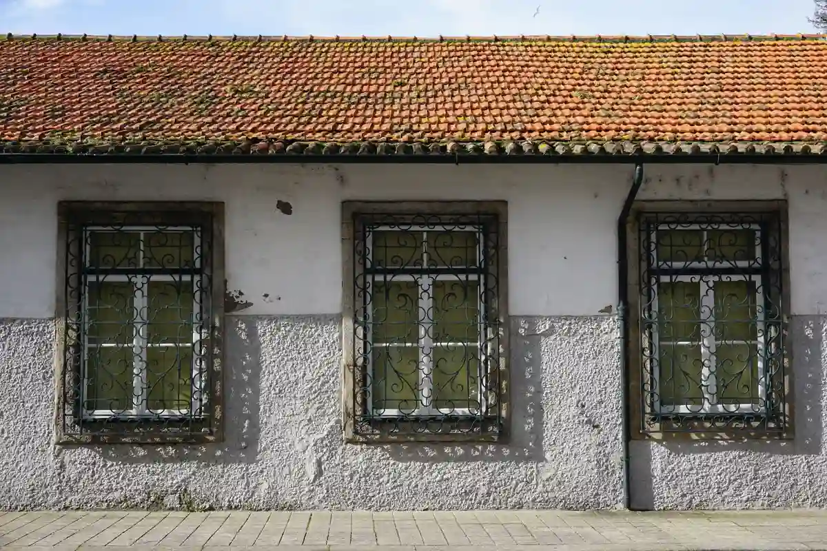 Before: Side elevation — veneer coursing with sill and cap detailing at window openings