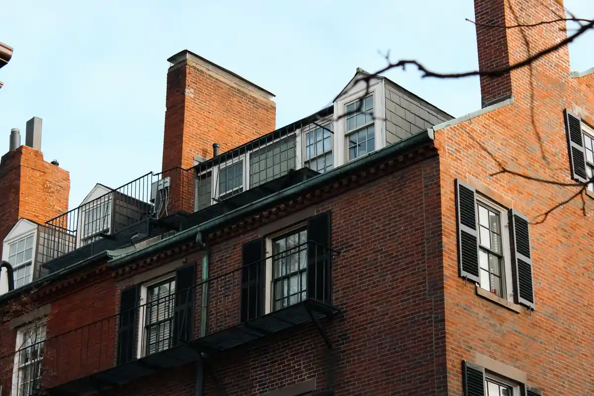 After: Full stack — original leaning chimney demolished to roofline and rebuilt in matching brick