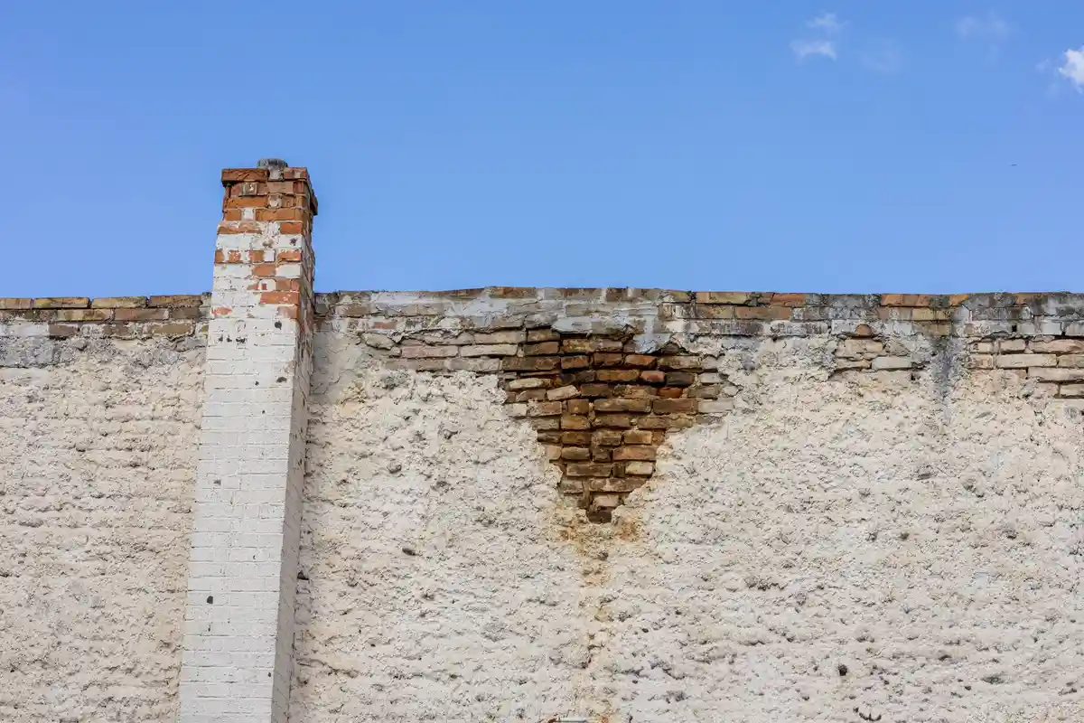 Before: Roofline detail — chimney proportioned to the elevation with code-compliant clearances