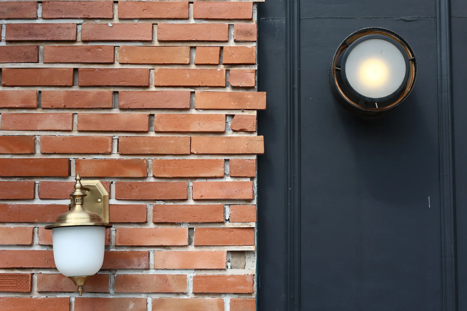 Our Vision — clean brick facade detail with modern exterior lighting