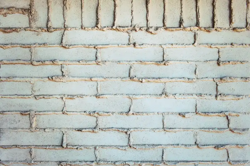 Pointing trowel packing fresh matched mortar into a joint